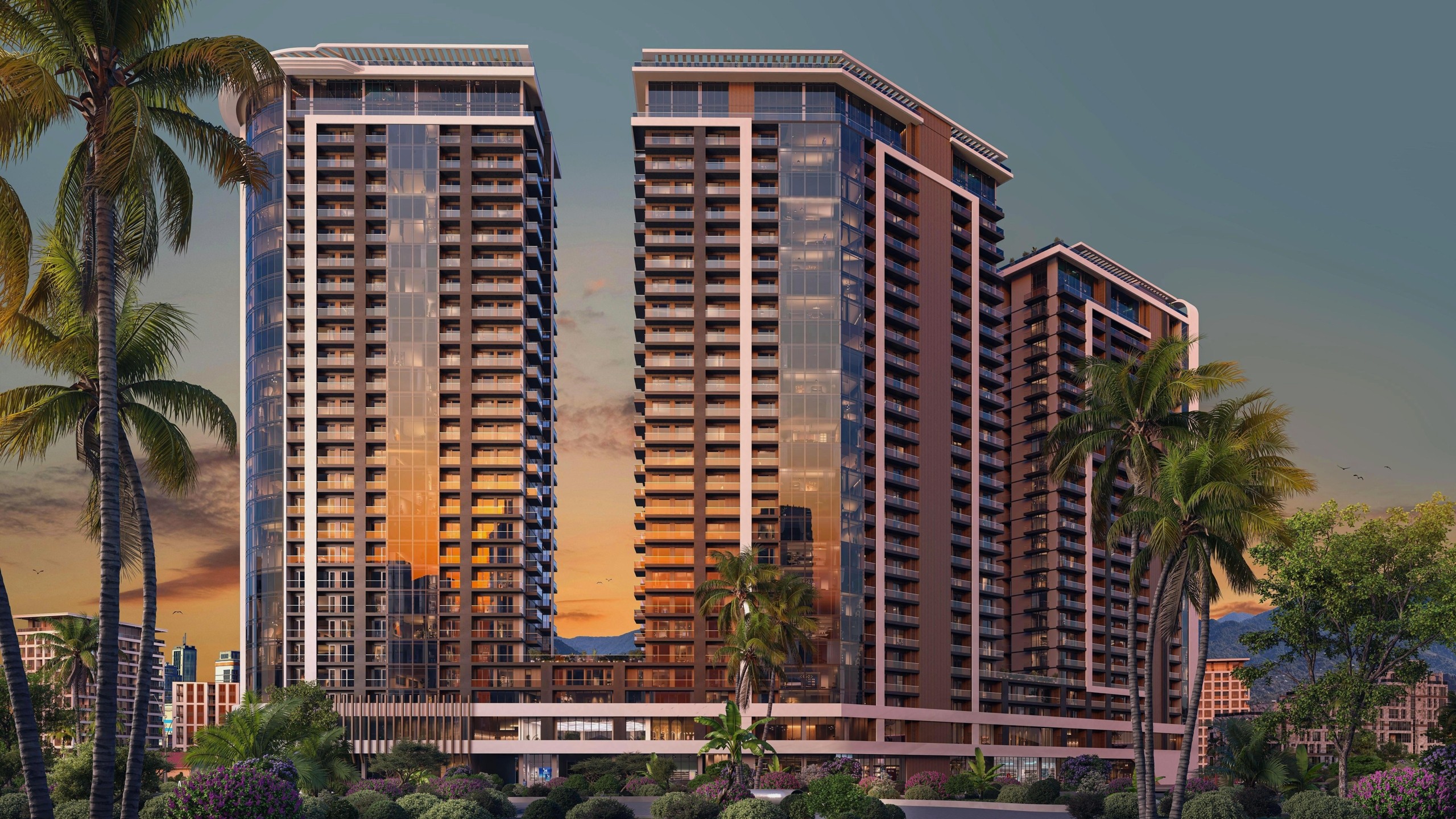 На изображении представлен реалистичный 3D-рендер внешнего вида современного жилого комплекса, состоящего из трех высотных башен с панорамным остеклением в окружении пальм и зелени.