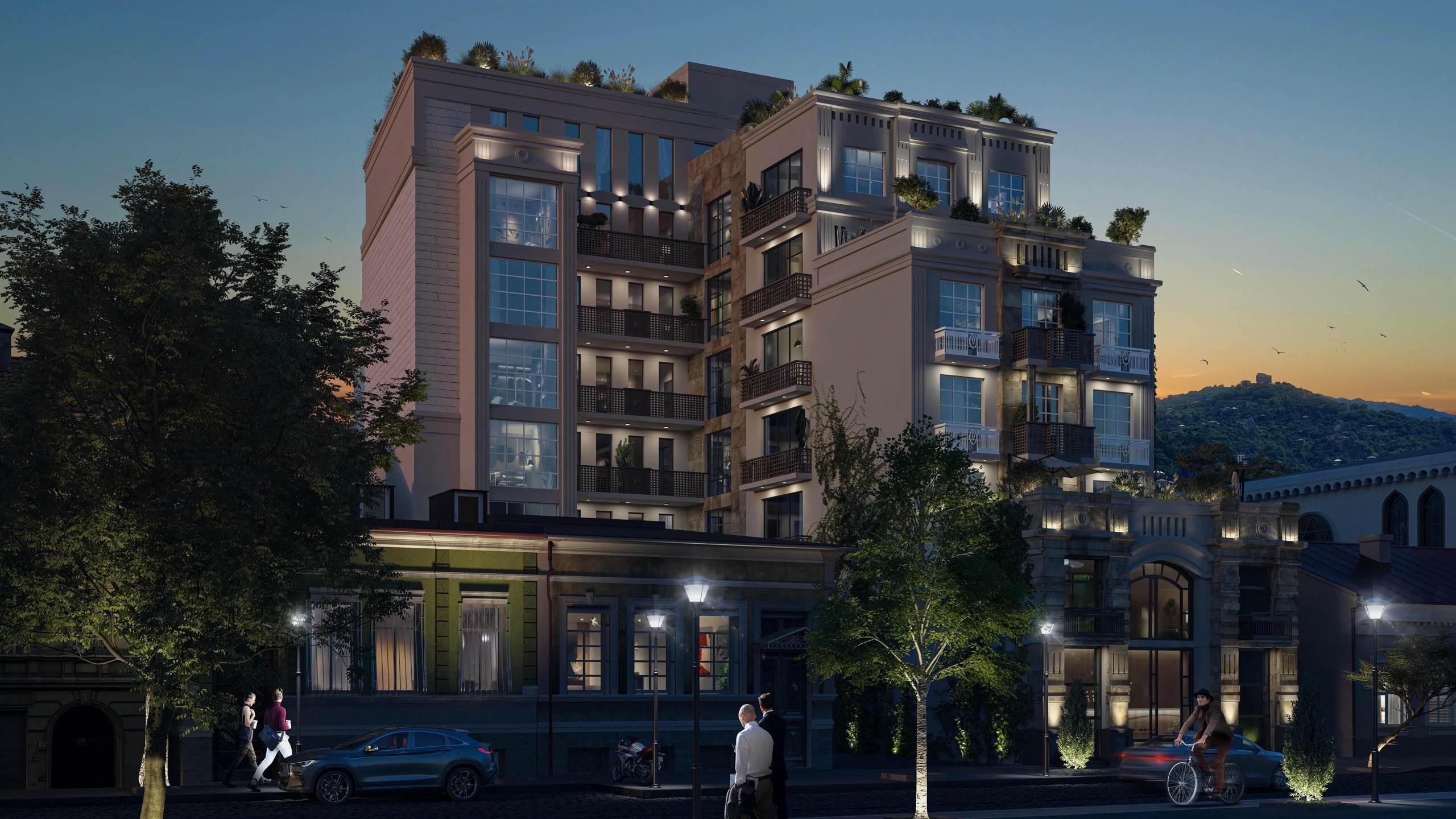 На изображении представлен реалистичный 3D-рендер фасада многоэтажного жилого дома в вечернее время. Визуализация демонстрирует архитектурную подсветку здания, интеграцию в городскую среду и людей на улице.