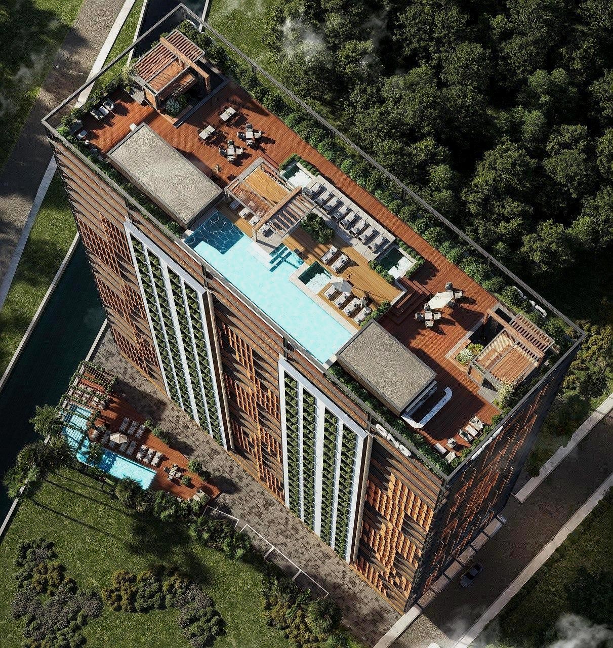 Реалистичный 3D-рендер многоэтажного здания с высоты птичьего полета, демонстрирующий зону отдыха с бассейном на крыше и окружающую зелень.