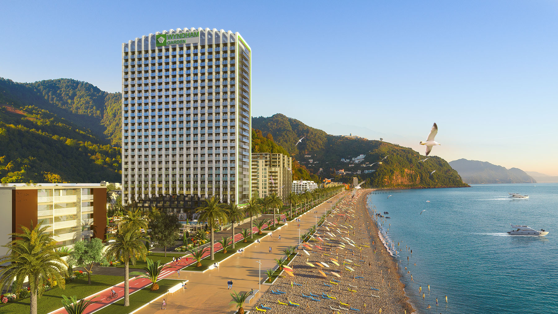 3D-визуализация многоэтажного отеля Wyndham Garden, расположенного на первой береговой линии с видом на море и горы. На изображении также показана благоустроенная набережная и пляжная зона.